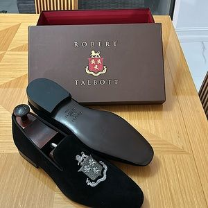 The man’s black suede with silver crest details